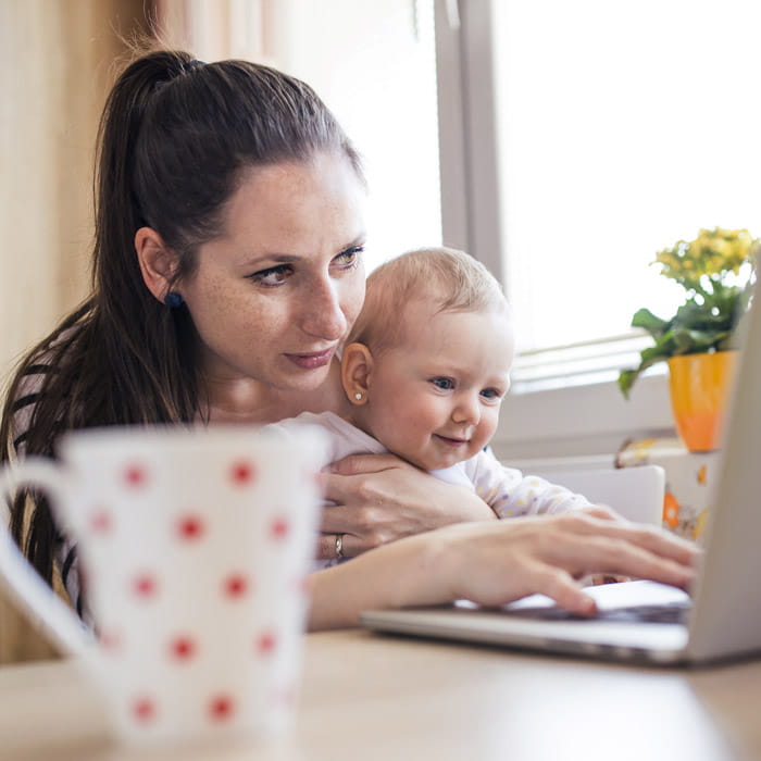 Mother and baby using laptop