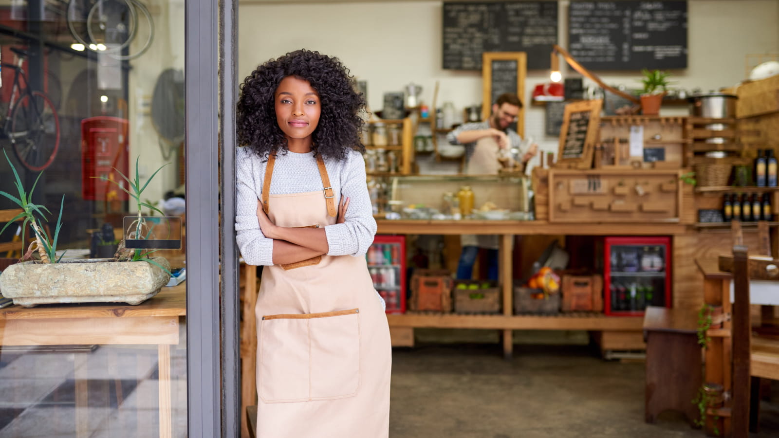 Woman standing by a shop door